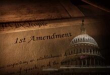 Close-up of the First Amendment text with the U.S. Capitol dome in the background