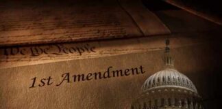 Close-up of the First Amendment text with the U.S. Capitol dome in the background