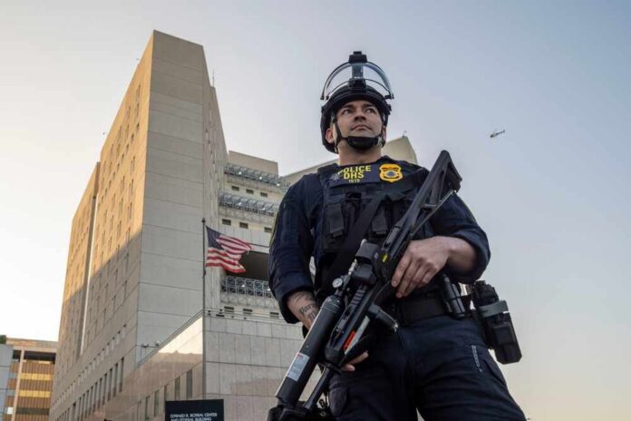 Police officer in tactical gear standing in front of a building