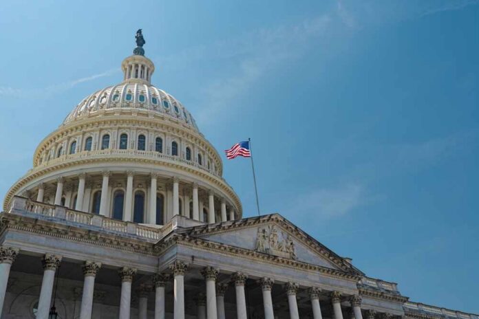 The U.S. Capitol building with an American flag flying against a blue sky