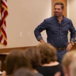 A speaker engaging with an audience in a professional setting