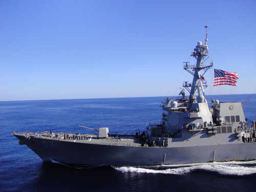 Coast,Of,California,-,May,20,,2012:,Us,Navy,Destroyer A naval destroyer sailing in the ocean with an American flag