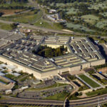 Aerial view of the Pentagon building surrounded by roads and greenery