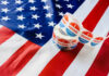 Voting stickers on an American flag background