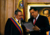 Cuba’s Fiery Outrage: Will U.S. Retaliate? Two officials examine a framed document during a ceremony