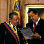 Cuba’s Fiery Outrage: Will U.S. Retaliate? Two officials examine a framed document during a ceremony
