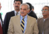 China, Pakistan, and Iran: The Quiet Power Alliance Group of men in formal attire engaged in conversation outdoors
