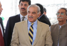 China, Pakistan, and Iran: The Quiet Power Alliance Group of men in formal attire engaged in conversation outdoors
