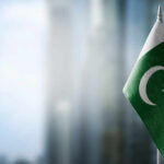 Secret Pact Exposed: Pakistan’s Battle-Ready Forces in Saudi Flag of Pakistan waving in a blurred urban background
