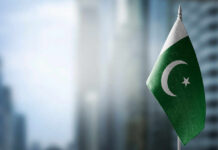Secret Pact Exposed: Pakistan’s Battle-Ready Forces in Saudi Flag of Pakistan waving in a blurred urban background