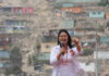 woman speaking into a microphone at an outdoor event