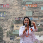 woman speaking into a microphone at an outdoor event