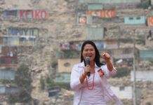 woman speaking into a microphone at an outdoor event