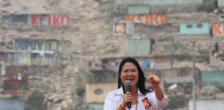 woman speaking into a microphone at an outdoor event