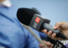 A hand holding a CNN microphone during a news interview