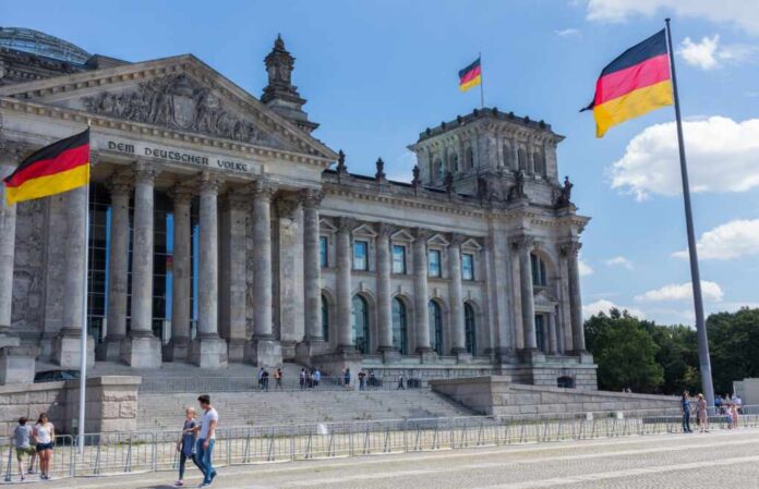 Berlin,Germany,-,Circa,August,,2016:,People,In,Front,Of The Reichstag building in Berlin with German flags and visitors