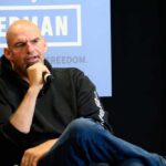 Person speaking into a microphone during an event