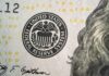 Close-up of a United States dollar bill featuring the Federal Reserve System seal