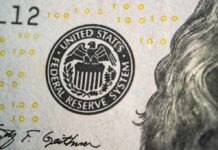 Close-up of a United States dollar bill featuring the Federal Reserve System seal