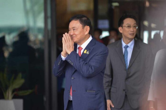 A man in a suit performing a traditional greeting gesture