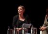 Privacy Threat ALERT: UK Scanning Phones Debate Explodes A woman speaking at a panel discussion with a focused expression