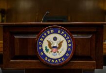 Podium with the United States Senate seal in a formal setting