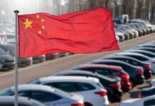 Chinese flag waving in a car park filled with vehicles