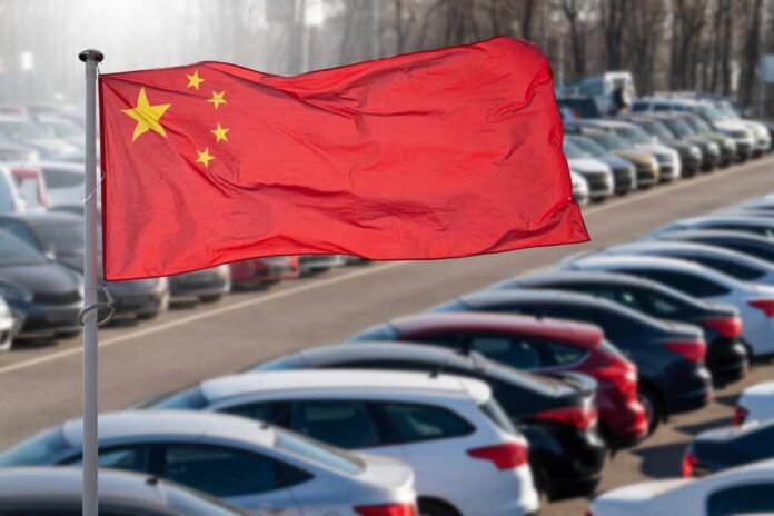Chinese flag waving in a car park filled with vehicles
