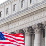 Immigration Judge’s Secret Termination Exposed Facade of a United States courthouse with an American flag in the foreground