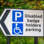 Disabled parking sign with left arrow