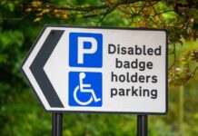 Disabled parking sign with left arrow