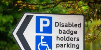 Disabled parking sign with left arrow