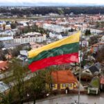 Lithuanian flag over a cityscape