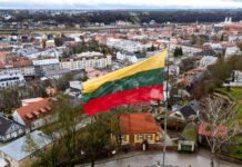 Lithuanian flag over a cityscape