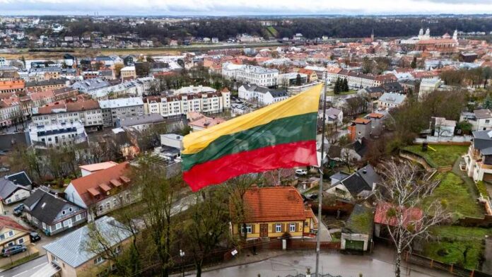 Kaunas,Panorama,With,The,Waving,Lithuanian,Flag Lithuanian flag over a cityscape