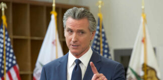 A government official speaking at a podium during a press conference