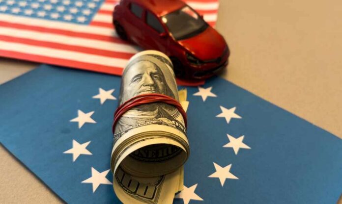 A rolled bundle of cash on a blue background with stars, next to a small red toy car and an American flag.