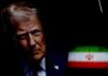 Close-up portrait of a political figure with the Iranian flag in the background