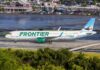 Frontier Airlines airplane on the runway at an airport