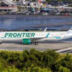 Airline Disaster: Trespasser Ignites Chaos at Takeoff Frontier Airlines airplane on the runway at an airport