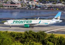 Frontier Airlines airplane on the runway at an airport