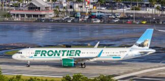 Frontier Airlines airplane on the runway at an airport