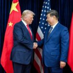 Why Skepticism Shadows the U.S.-China Deal Two political leaders shaking hands in front of national flags