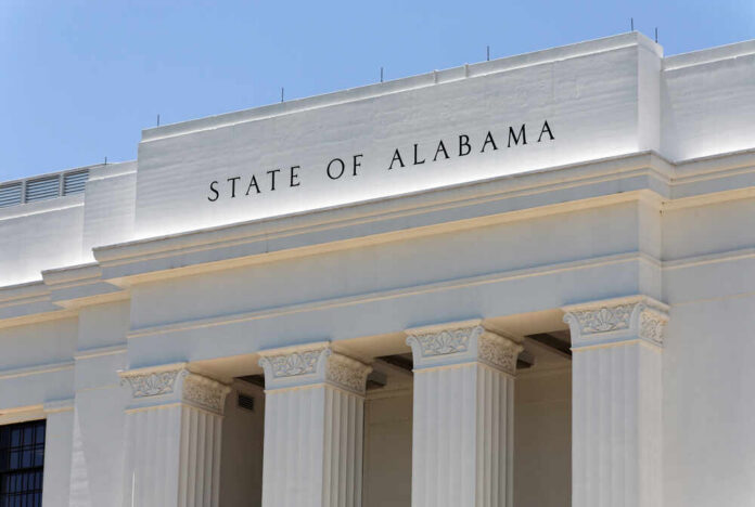 A,Government,Building,In,Montgomery,,The,Capital,City,Of,Alabama. Facade of a government building with the words 'STATE OF ALABAMA' displayed prominently