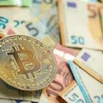 Bitcoin coin on scattered euro banknotes