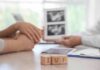 Baby Swap Panic Exposes Broken System Couple consults doctor with ultrasound images and IVF blocks on desk