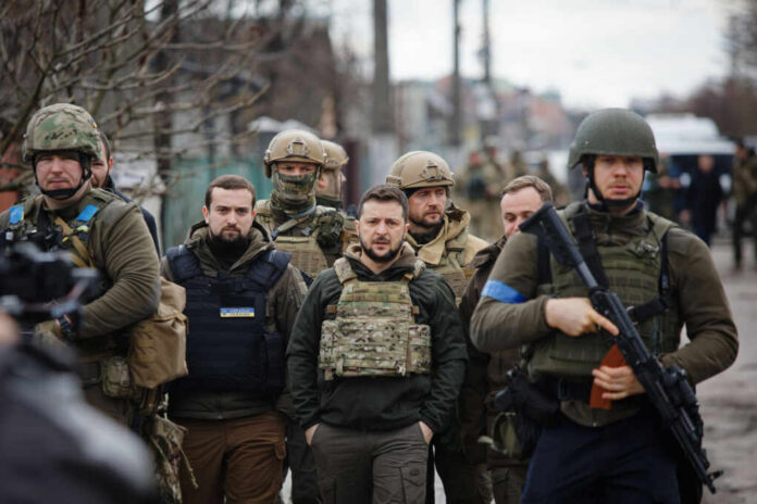 shutterstock2148138401jpg A group of military personnel in tactical gear walking through an urban area