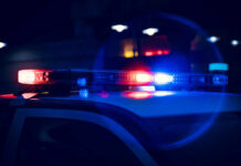 Close-up of police car lights flashing at night