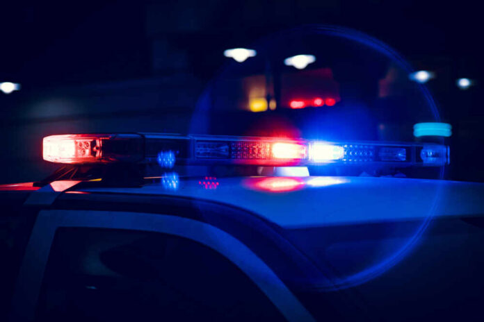Closeup,Of,Police,Lights,On,Dark,Street,At,Night Close-up of police car lights flashing at night