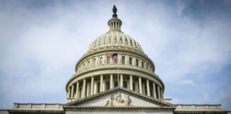 The U.S. Capitol building with an American flag flying in front